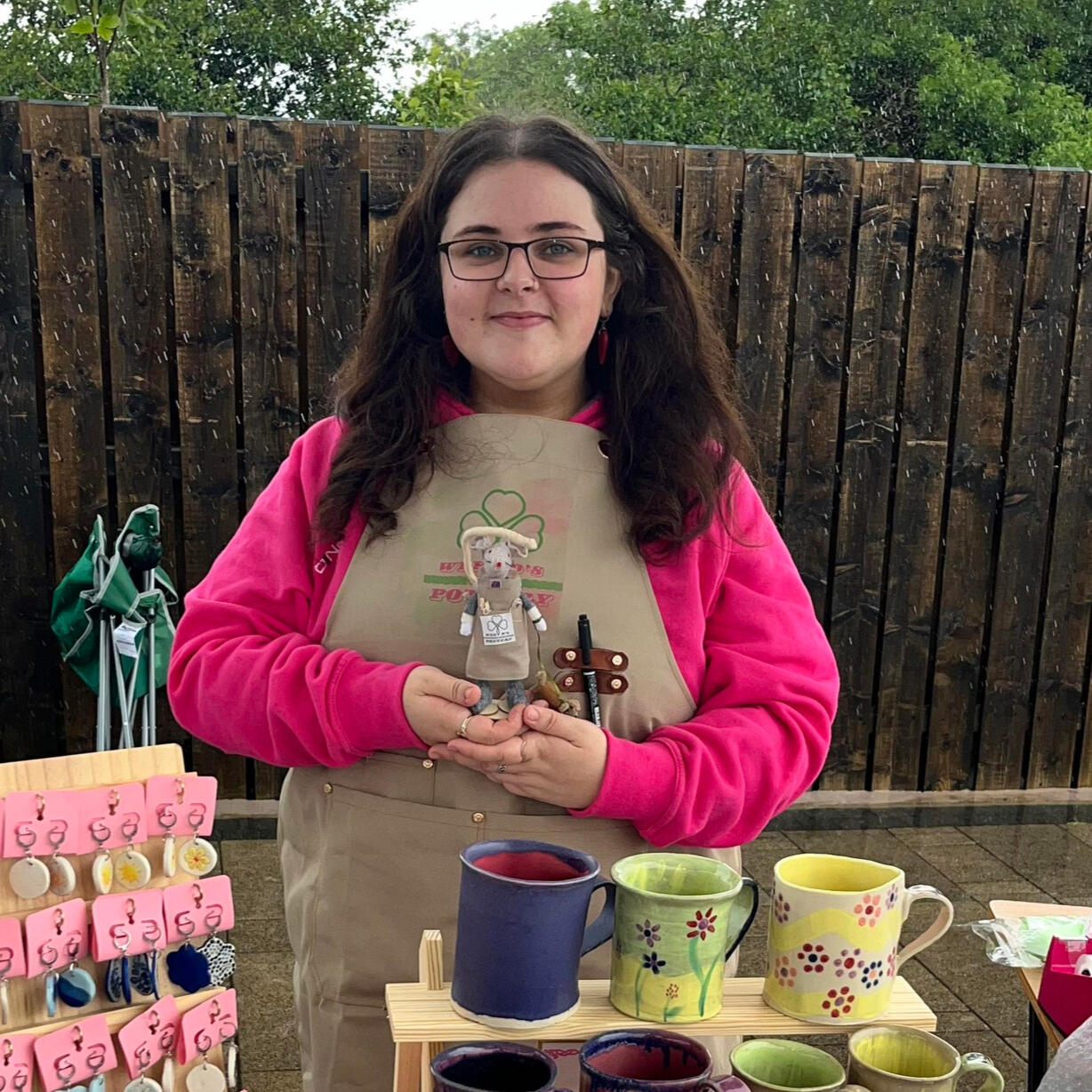A photo of me, Dearbhla, at a trade fair with a selection of hand-crafted pottery